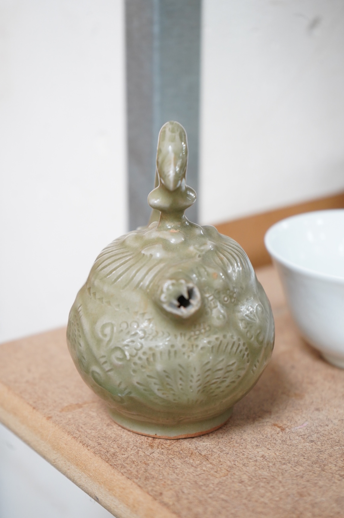 A collection of Chinese porcelain and pottery to include a naturalistic teapot, crackle glaze bowl and a ‘dragon’ bowl, largest 10cm in diameter